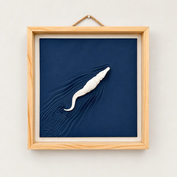 Alligator wall art with navy sculpted wake, natural wood frame and rope hanger, front view