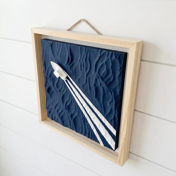 Boat wake wall art with a natural wood-style frame, image 1.