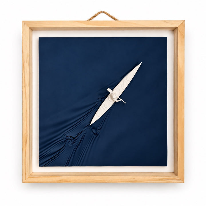Kayaker wall art, front view of a bone-white kayak and paddler on navy sculpted water in a natural wood frame