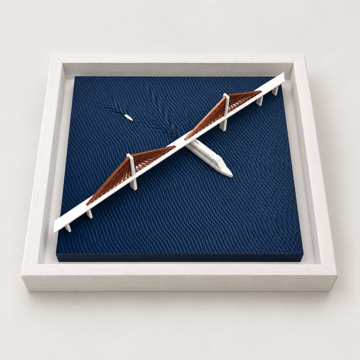 Angled view of Sunshine Skyway Bridge wall art with copper-colored cables, white boats and navy textured water in a white frame.